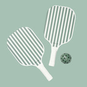 A pair of sage green and white striped pickle ball paddles with a green wiffle ball.
