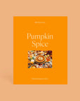 Orange box of puzzle that reads "Pumpkin spice". The puzzle image is on top of the box and the puzzle includes an aerial shot of pumpkin pie with cinnamon rolls, cups of coffee, marshmallows and a wide table spread of Fall themed clutter.