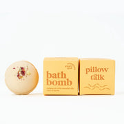 On a white background is a yellow bath bomb with a yellow box beside it that reads, "bath bomb enhanced with essential oils, clays and herbs". 