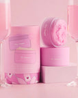 A set of a body butter and a body scrub with a pink champagne scent.