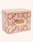 A metal recipe box with a pink daisy pattern with recipe cards and dividers.