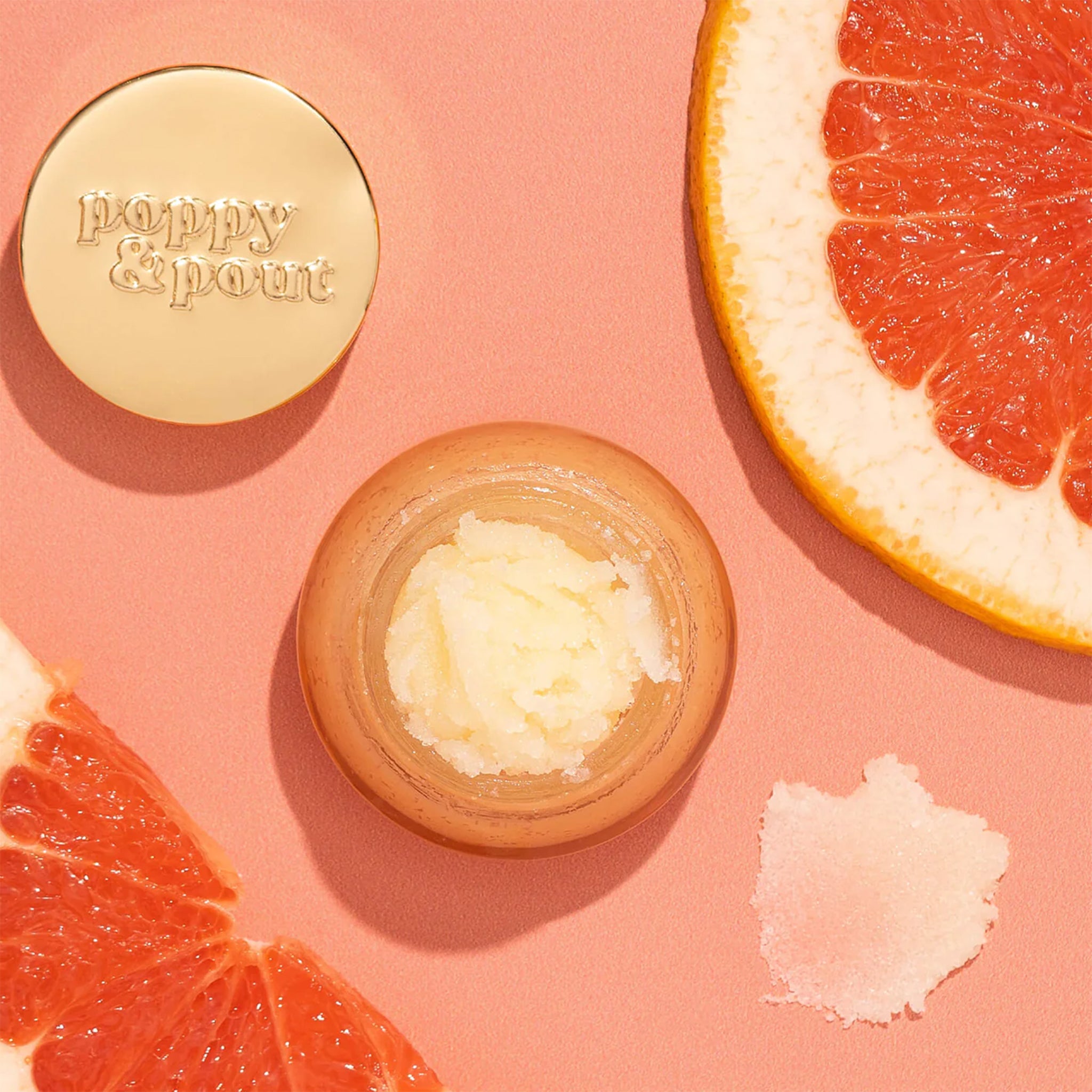  Lip scrub in a light orange colored container with a gold lid. This lip scrub is grainy, hydrating and perfect for your lips.