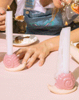 A photo of a table scape with the pink snail shaped candle holder.