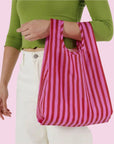 A pink and red striped nylon tote bag.
