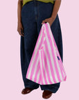A pink and white striped nylon tote bag.