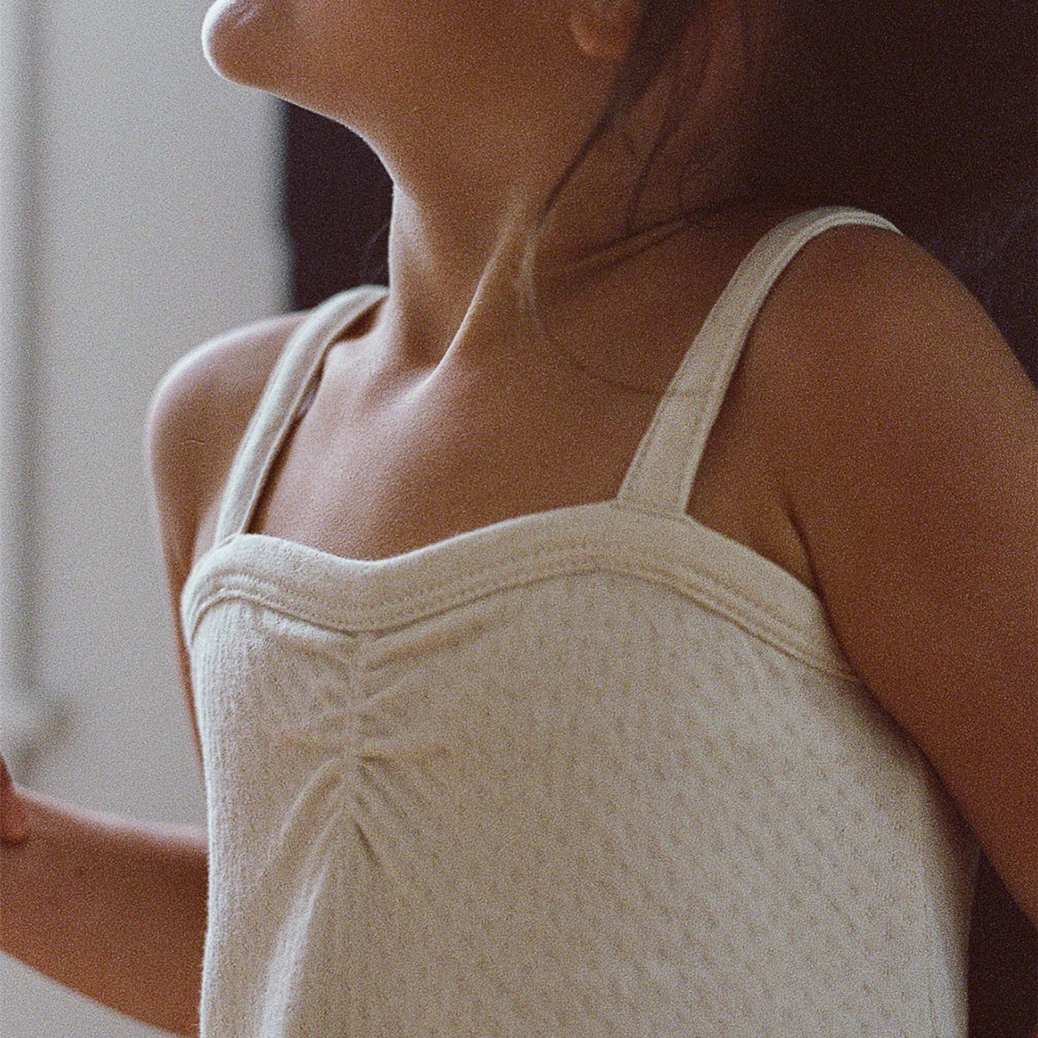 A close up of the top of the dress worn on a children's model. 