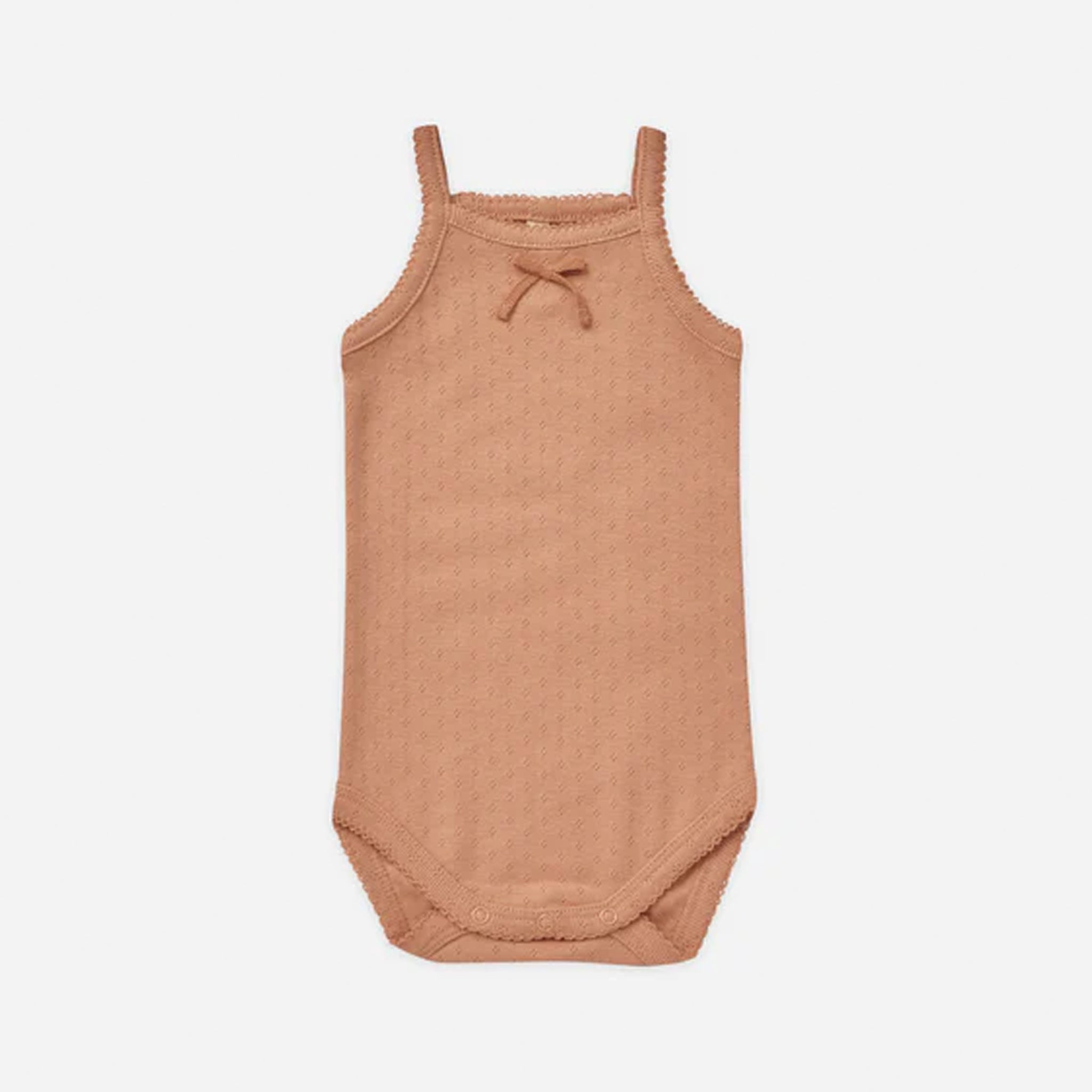 On a white background is a light orange tank onesie with snap closure and a small bow detail at the top.