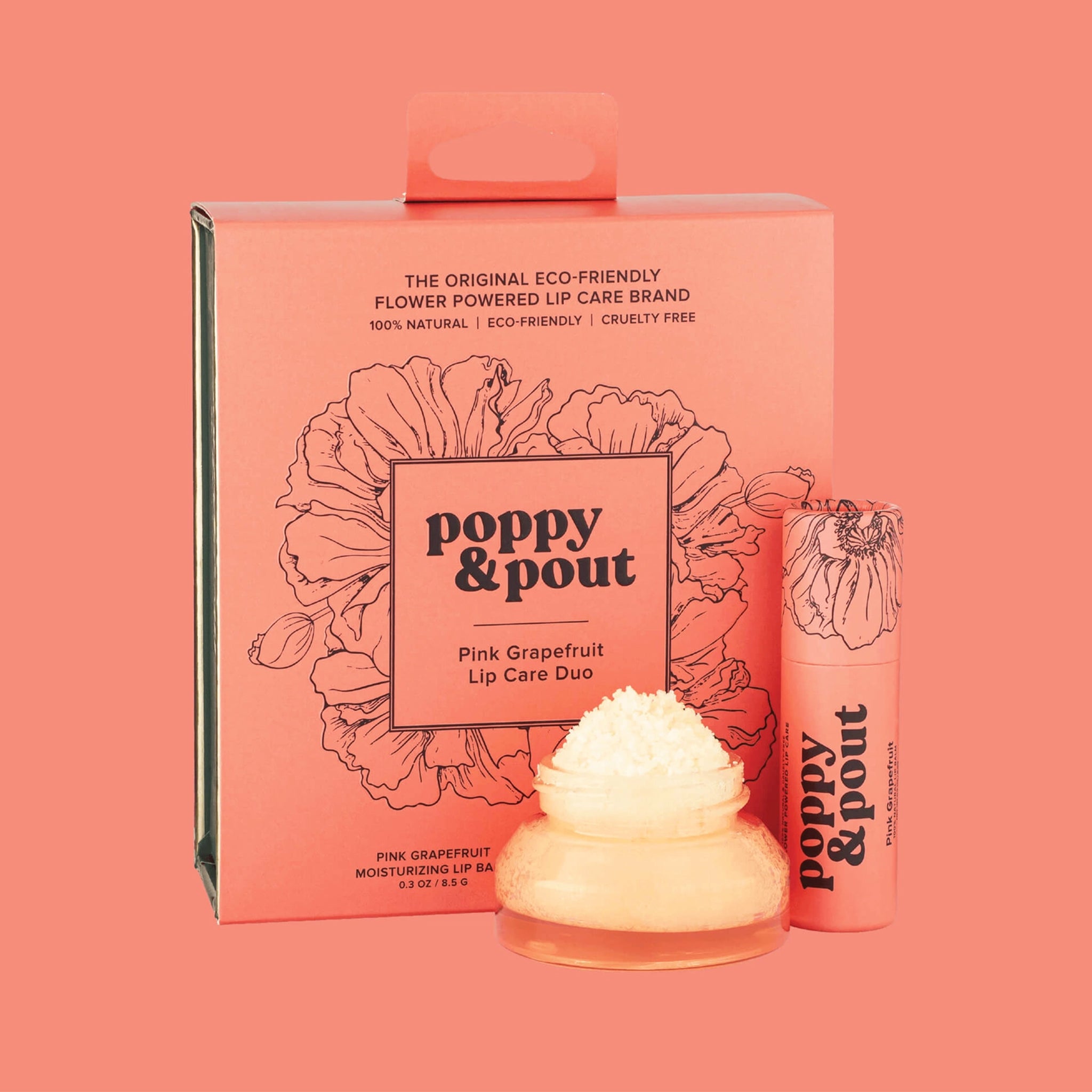 A box filled with a lip scrub and apricot colored lip balm tube. 
