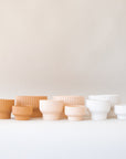 The latte presley bowls next to two other color ways in light pink shade and white.