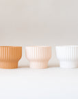 The latte presley bowls next to two other color ways in light pink shade and white.
