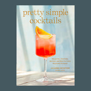 A light blue bar book with a cocktail on the front with text that reads, 'pretty simple cocktails'.