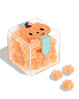 A clear acrylic colored box of orange sour star candies with a pumpkin graphic on the front.