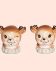 A pair of ceramic salt and pepper shakers in the shape of holiday reindeer heads.
