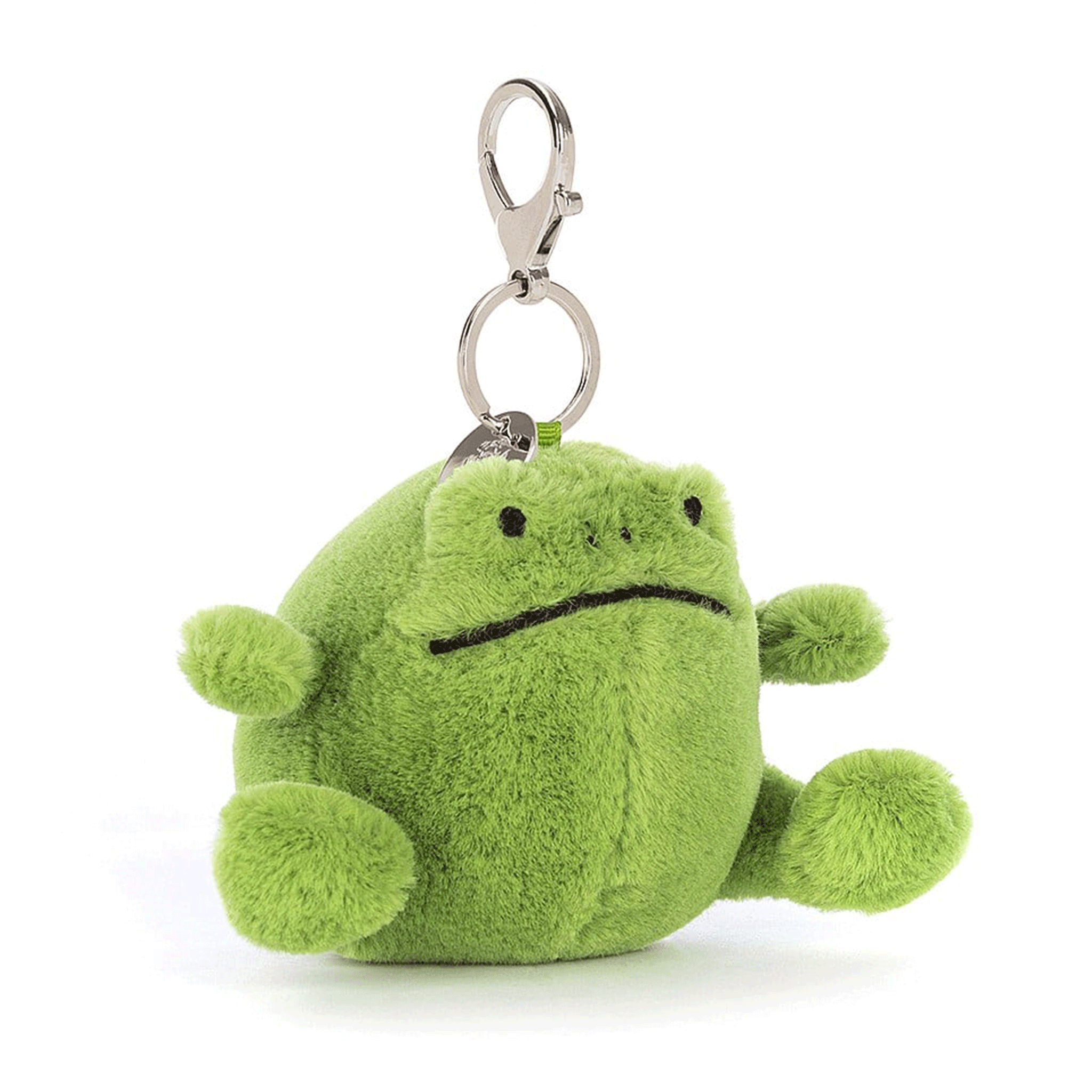 On a white background is a small green stuffed toy frog shaped bag charm. 