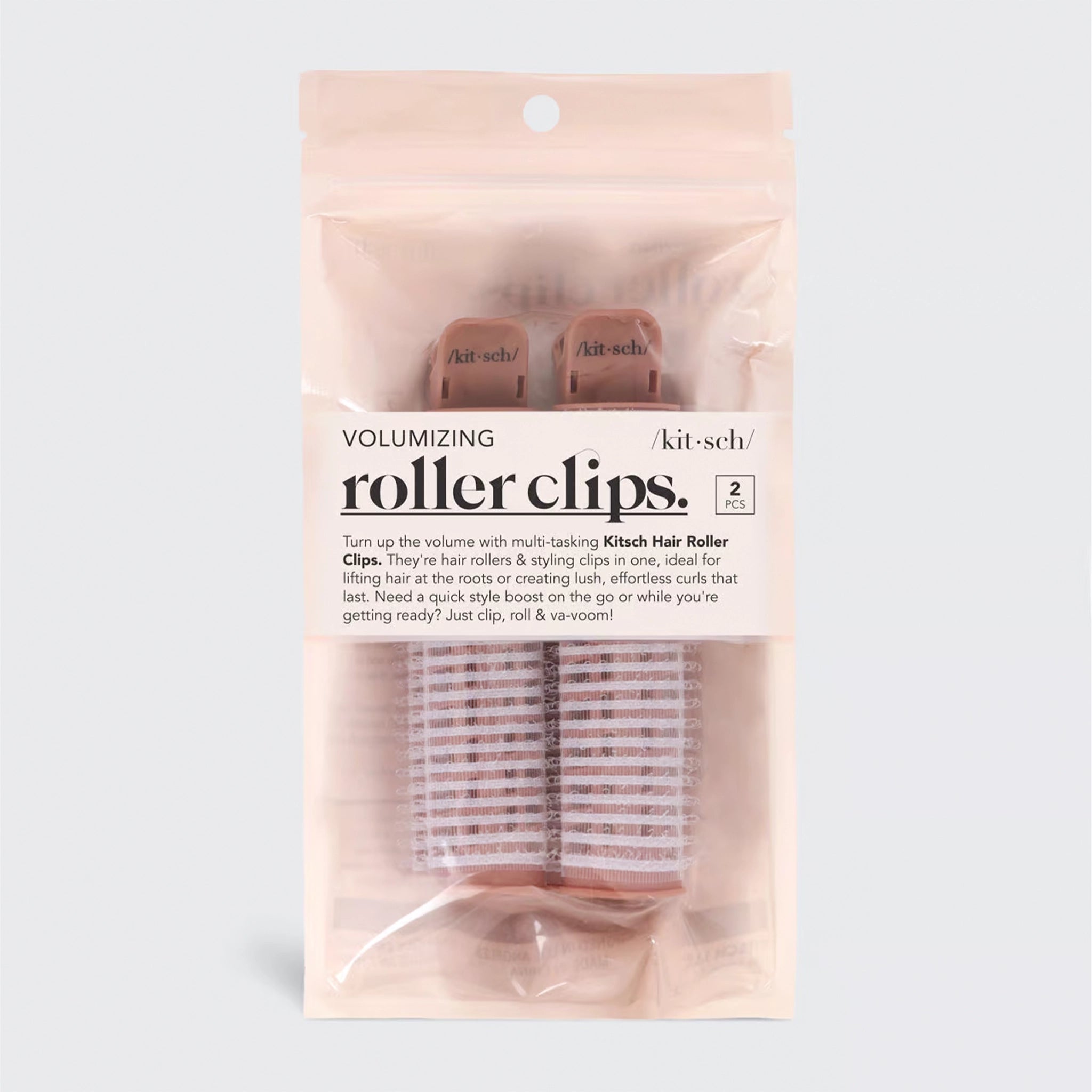 On a white background is a set of volumizing roller clips in their pink packaging. 