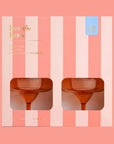 A margarita glass set that is orange in a pink and coral striped box.