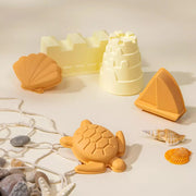 A set of five sand moulds in the shape of a shell, a turtle, a sailboat, and a castle.