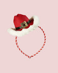 A red and white headband with a red cowboy hat shaped "Santa" inspired hat on top of it.