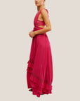 A hot pink maxi dress with a ruffle detail with a v-neckline with a bandeau style piece underneath.