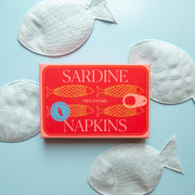 A set of four light blue sardine shaped cloth cocktail napkins.