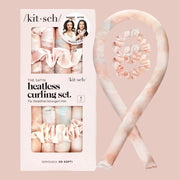 A photo on a white background of the pink satin heatless curling set next to the packaging that it comes in.