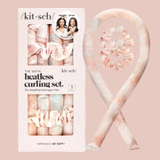 A photo on a white background of the pink satin heatless curling set next to the packaging that it comes in.