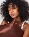 A chocolate brown satin pillow case.
