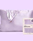 A purple satin pillowcase next to the packaging that it comes in.