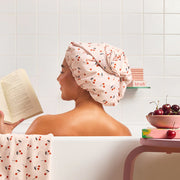 A light pink and cherry printed satin shower cap.