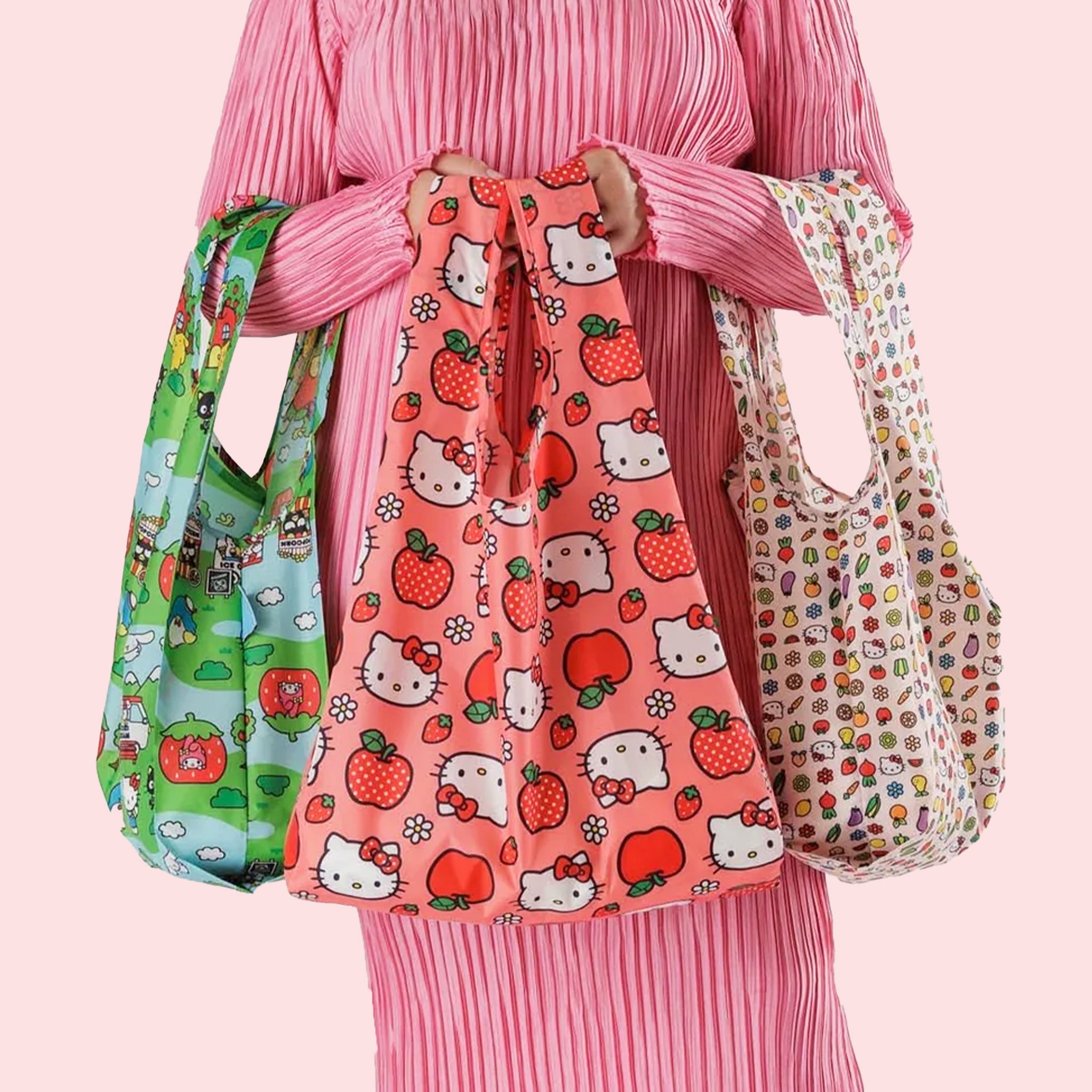 A set of three standard Baggu tote bags with three different Hello Kitty prints on them.
