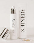 A bottle of jewelry wash soap with silver detailing and text that reads, 'Shinery Radiance Wash'.