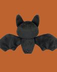 A black bat shaped skeleton stuffed toy.
