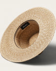 On a white background is a tan woven sun hat with a band around the base of the hat.