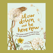 A light mint green children's book with illustrations of dandelions and a small critter peaking out from it along with the title of the book in the center that reads, "Slow down and be here now more nature stories to make you stop, look, and be amazed by the tiniest things" in brow letters.