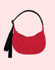 A small red nylon handbag with a back adjustable strap.