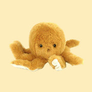 A mustard yellow octopus shaped stuffed animal toy.
