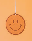 A yellow smiley face car air freshener.