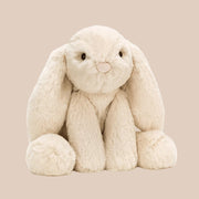 Plush bunny toy on a beige background