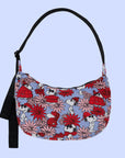 A blue and red floral and Snoopy print crescent shaped nylon handbag with a black adjustable logo strap.
