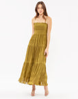 An olive green tiered midi dress with spaghetti straps.