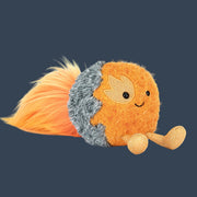 An orange comet shaped stuffed toy.