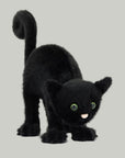 A black cat shaped stuffed animal toy with a spooky arched back.