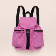 On a cream background is a bright pink nylon backpack with a drawstring closure with a flap overtop that buckles in the front as well as black straps and two side pockets. 