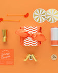 A gift box themed with accessories to go along with an aperol spritz.