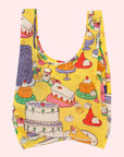 A yellow nylon tote bag with a colorful pattern of various desserts.