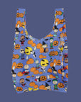 A purple reusable nylon bag with a charlie brown pumpkin patch pattern all over.