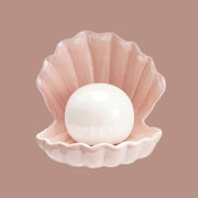 A clam seashell shaped lamp with a round light in the center.