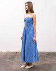 Model is wearing a strapless A-line midi dress, in a stripe blue pattern.