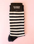 A pair of black and cream striped crew socks.