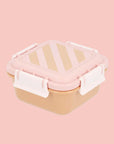 A lunch box with a pink and orange stripe.